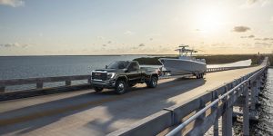 2024 GMC Sierra 2500 HD driving over a bridge of water.