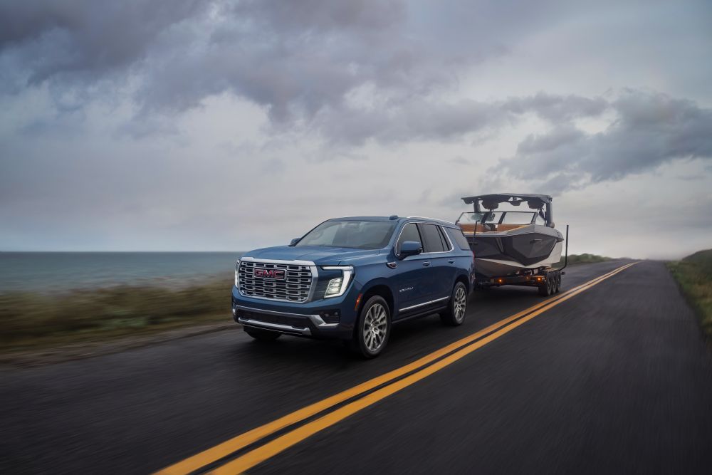 Blue GMC Yukon towing a boat