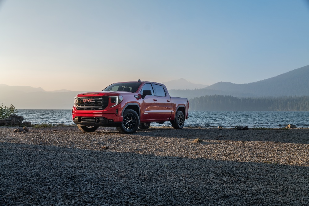 Red GMC Sierra 1500 parked along side a body of water