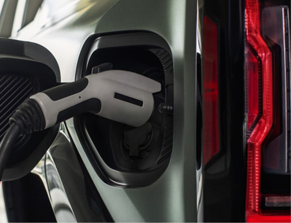 Close up of charging port with charger plugged in on a GMC Hummer EV SUV - Century Buick GMC in Tampa FL