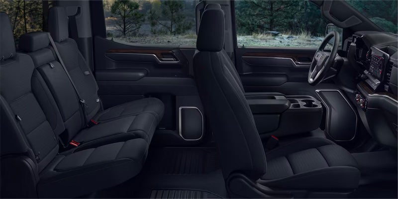 View of the front and back black leather seats in a 2024 GMC Sierra 1500