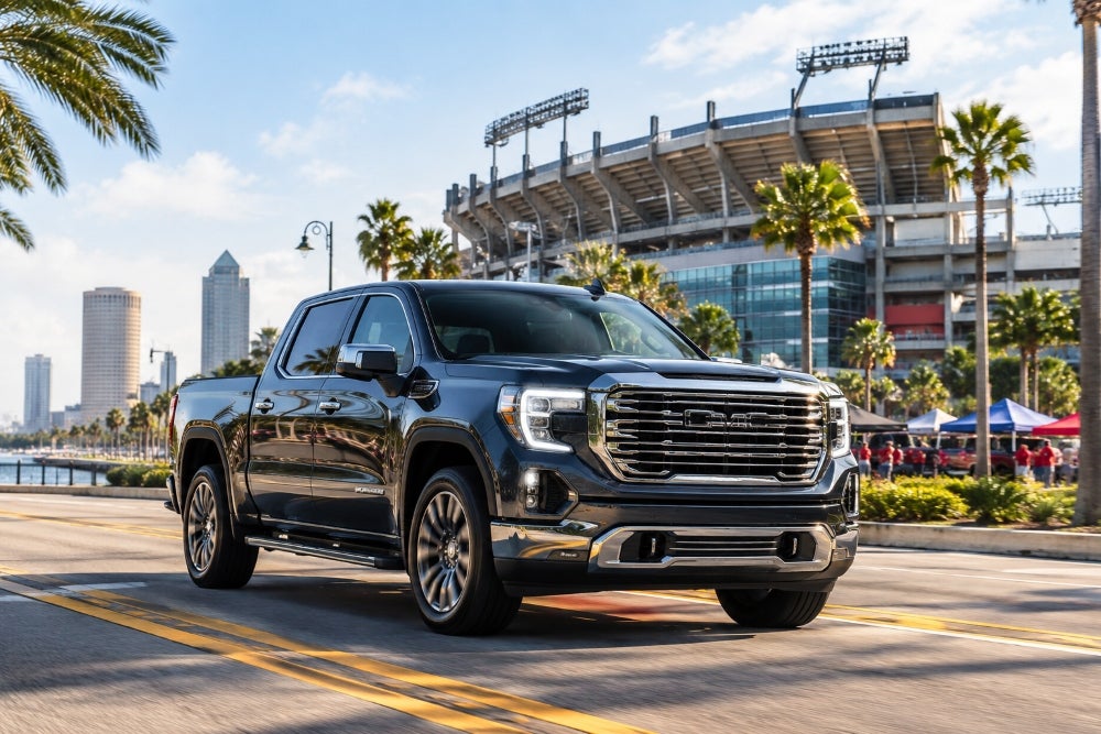GMC Sierra driving by Tampa football stadium
